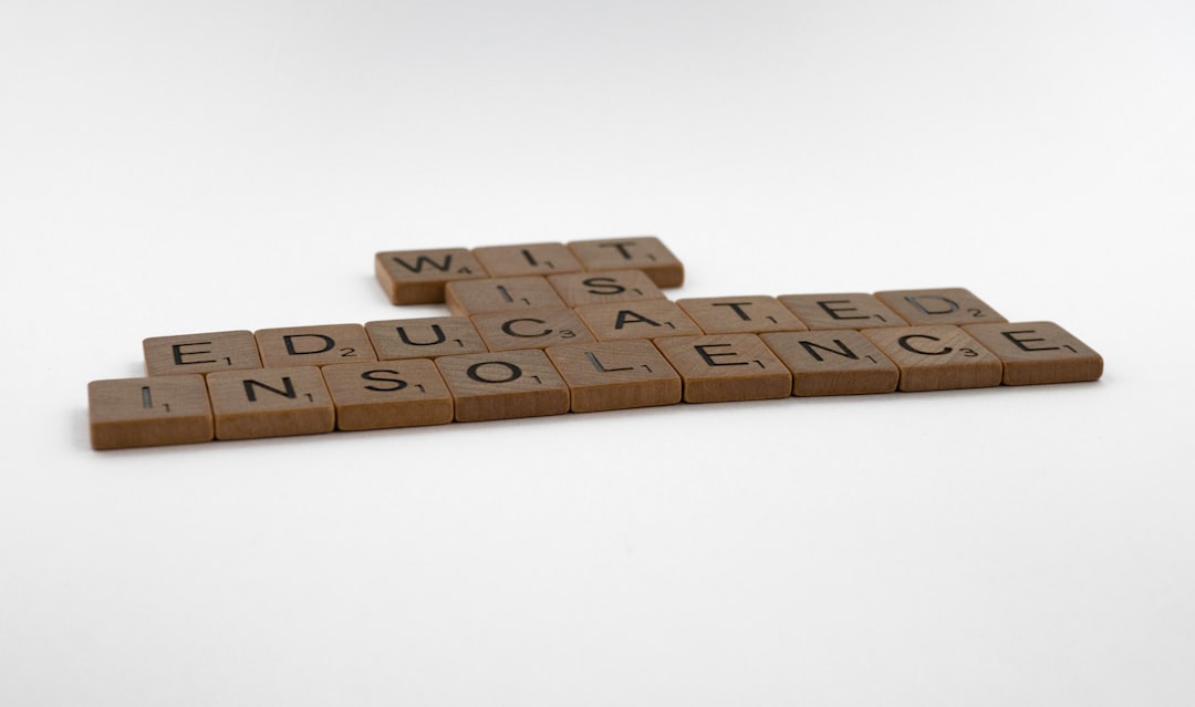 scrabble, scrabble pieces, lettering, letters, wood, scrabble tiles, white background, words, quote, letters, type, typography, design, layout, focus, bokeh, blur, photography, images, image, wit is educated insolence, wit, education, writing, humour, humor, intelligence, learning, socrates,
